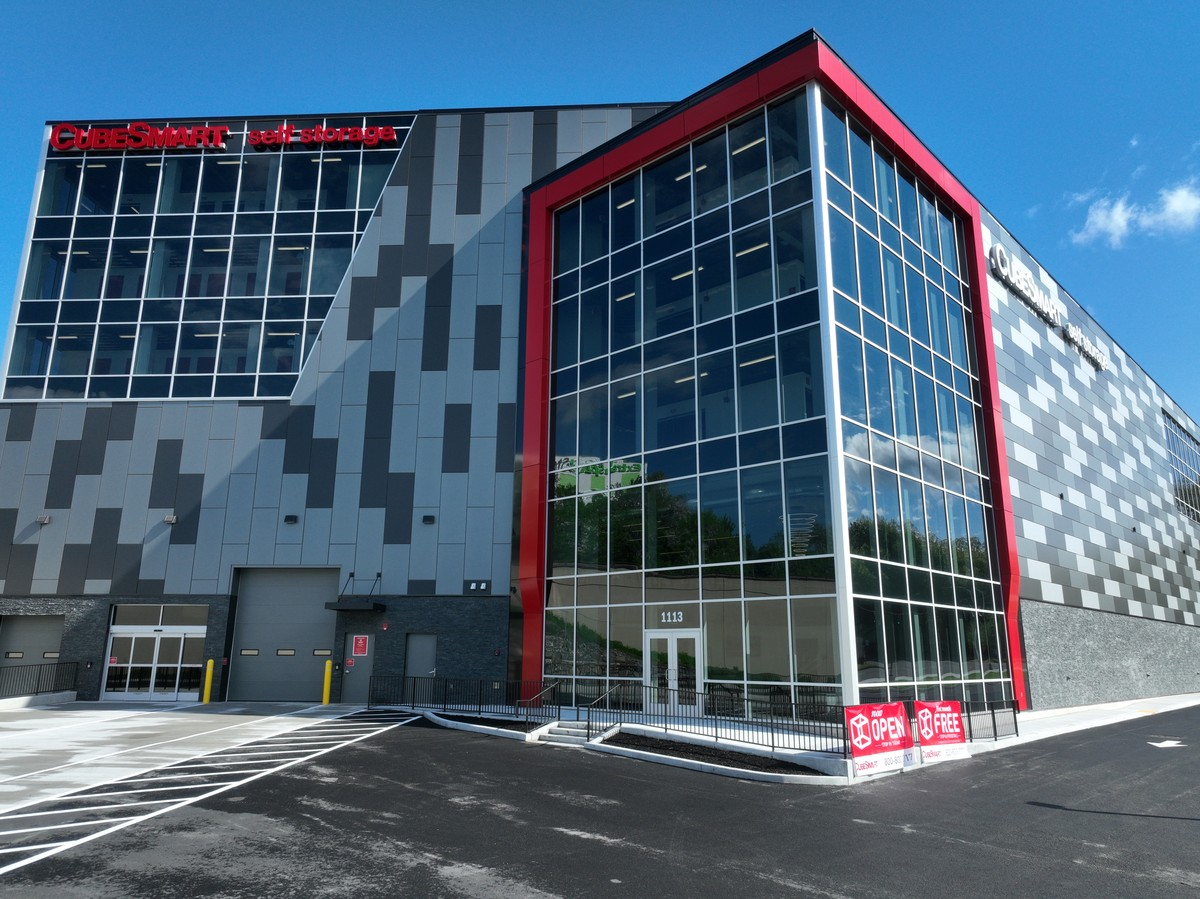 Full photograph of the Yonkers facade with patterned panels, glazed corner, CubeSmart signage and entrance